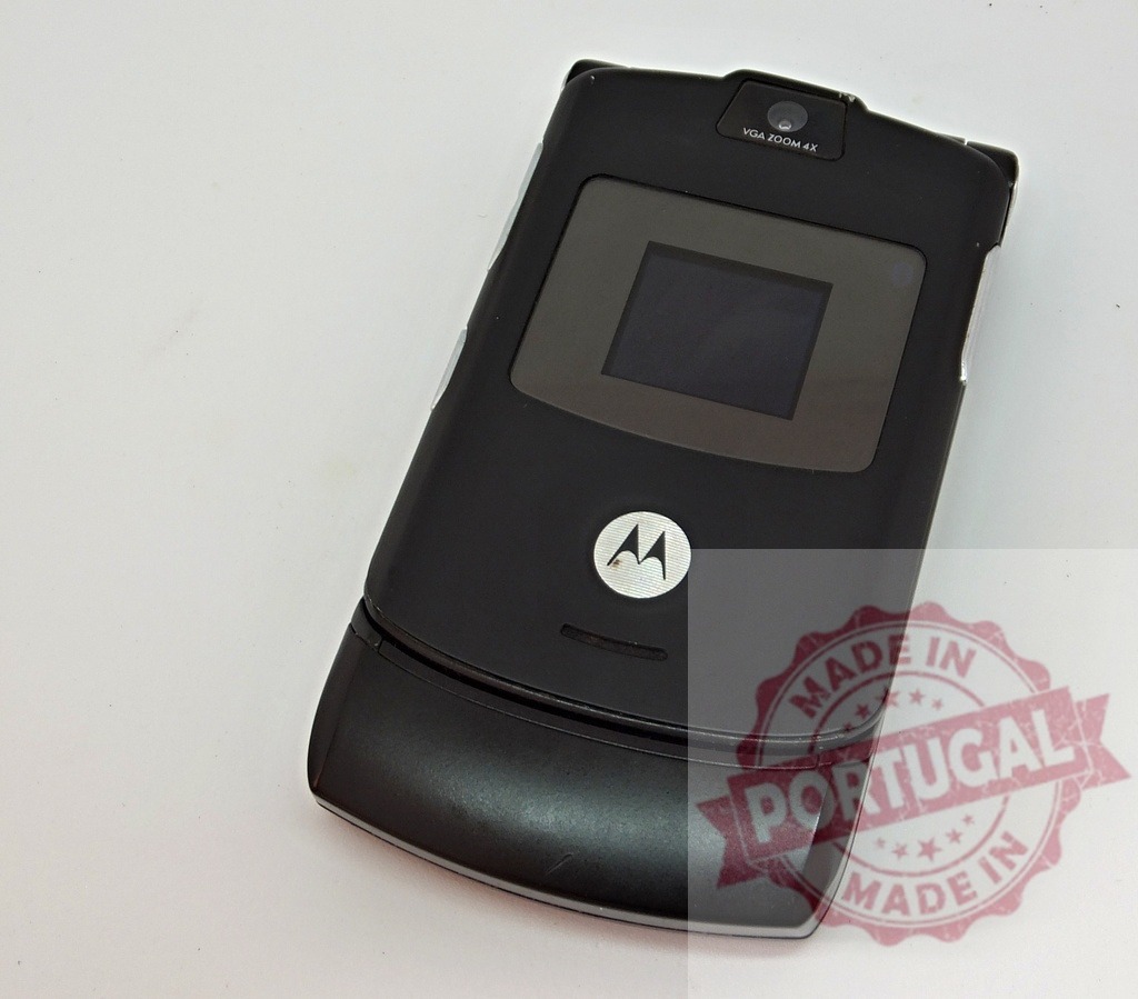 Motorola flip phone isolated on white background showing off its screen | Old vintage Motorola cell phone isolated on white background showing its screen - Realized with Pictrs.com