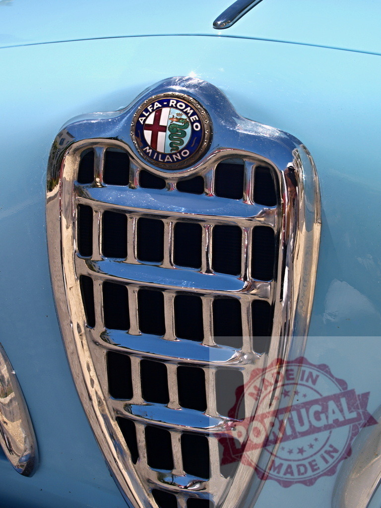 Shiny chrome grille and Alfa Romeo logo decorating a classic pastel blue car | Close-up of a gleaming chrome grille and Alfa Romeo logo on a vintage pastel blue car, showcasing timeless automotive design - Realisiert mit Pictrs.com