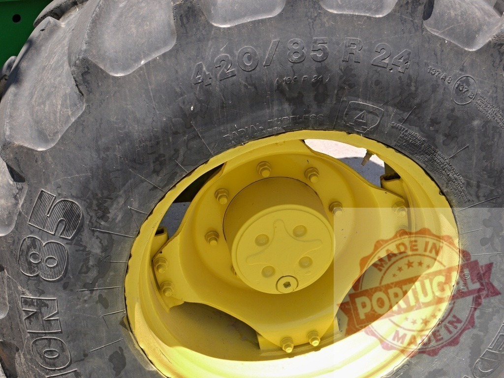 Tractor tire with yellow rim and deep treads | Tractor tire showing industrial rubber and yellow metal rim - Realized with Pictrs.com