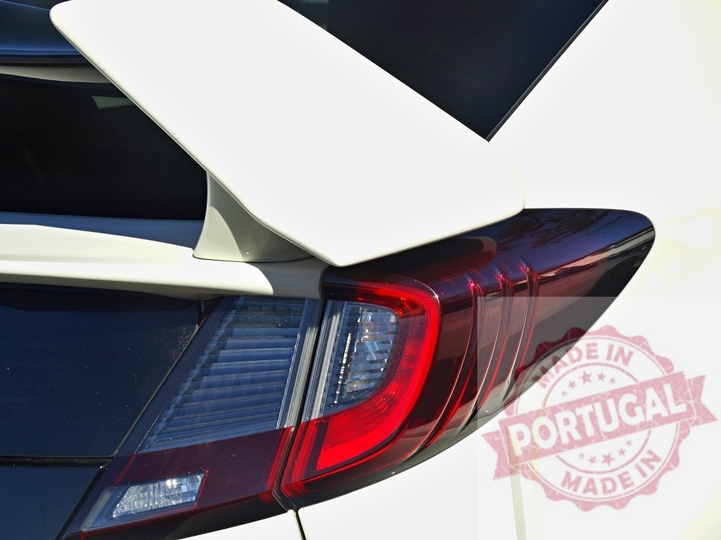 White car spoiler and red tail light detail | White vehicle spoiler and red tail light forming part of modern car design - Realized with Pictrs.com