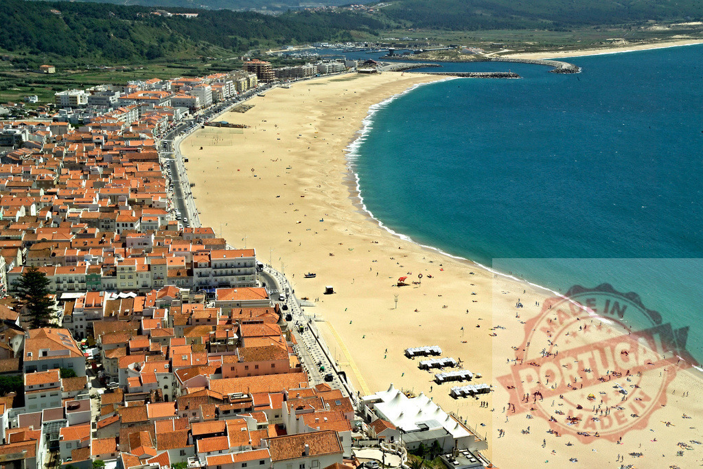 Nazaré Portugal town and beach aerial view | Nazaré town and wide sandy beach stretching along the Atlantic Ocean coastline - Realized with Pictrs.com