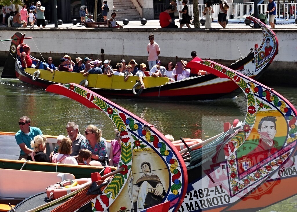 Aveiro moliceiro boats with tourists on canal. Aveiro - Portugal | Tourists enjoying a ride on traditional moliceiro boats in Aveiro, Portugal - Realisiert mit Pictrs.com
