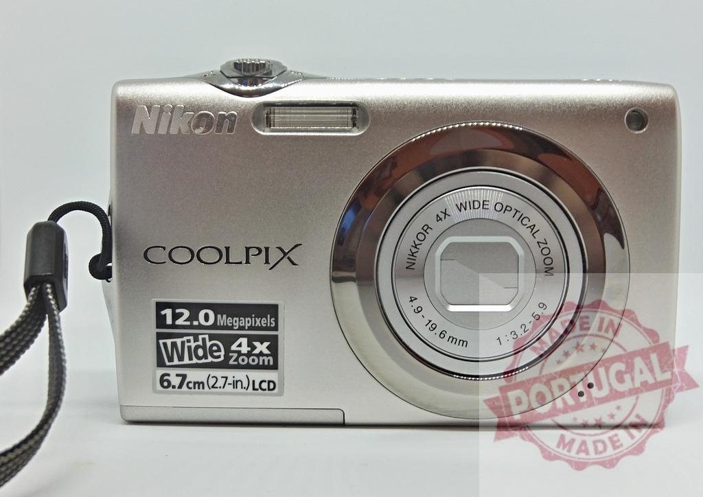 Nikon Coolpix digital camera with silver finish | Nikon Coolpix compact digital camera on a white background, ready for capturing memories - Realized with Pictrs.com