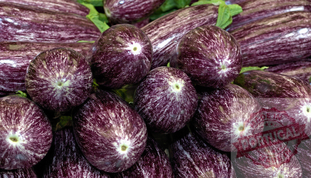 Fresh striped eggplants creating organic texture pattern | Fresh striped eggplants with purple and white skin stacked together at a market - Realized with Pictrs.com