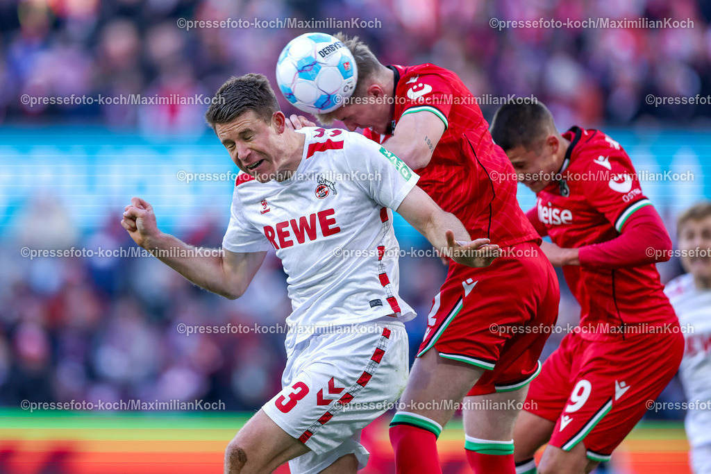 1FC30112401024 | 30.11.2024, Fußball, 1. FC Köln - Hannover 96, 2. Fußball Bundesliga, RheinEnergieSTADION, Saison 2024 2025: Zweikampf Kopfball Dominique Heintz (1.FC Köln #3) gegen Josh Knight (Hannover #2) und Nicolo Tresoldi (Hannover #9)DFB regulations prohibit any use of photographs as image sequences and or quasi-video.