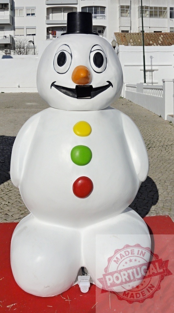 Giant snowman shaped water tank standing on red carpet | Large white plastic snowman water tank with black top hat, orange nose and colorful buttons standing on red carpet - Realized with Pictrs.com