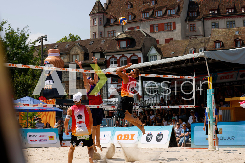 Obi BeachTour 2026 - Basel | BASEL, SWITZERLAND - JULY 19: MORITZ KINDL (AUT) attack / spike against MATHIS KÄLIN (SUI) block during the Obi BeachTour 2026 match between LEITNER / KINDL (AUT) and BREER / KÄLIN (SUI) at Barfüsserplatz on July 19, 2026 in Basel, Switzerland. - Realisiert mit Pictrs.com