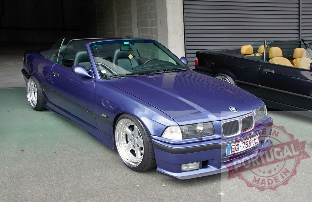 Customized BMW M3 E36 convertible parking in garage | Tuned BMW M3 E36 convertible with custom rims parked next to another BMW in a garage - Realized with Pictrs.com