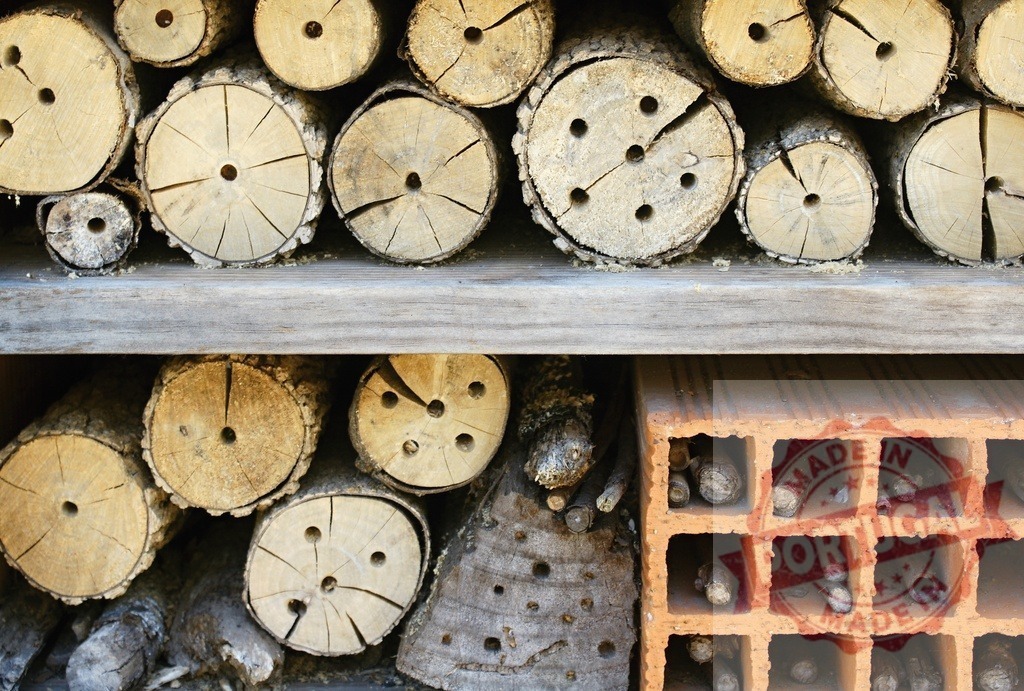 Insect hotel providing shelter for garden biodiversity | Insect hotel with drilled logs and terracotta bricks offering shelter for wild bees and other insects - Realized with Pictrs.com