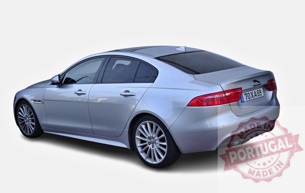Silver Jaguar XE showing its rear on white background | Rear view of a silver Jaguar XE on a white background, showcasing its elegant design and sporty features - Realized with Pictrs.com