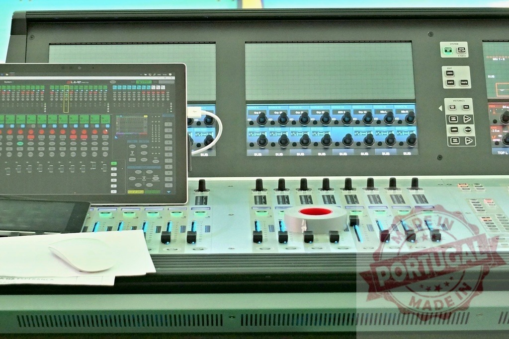 Professional digital audio mixing console with tablet showing mixing software and faders | Digital audio mixing console in a recording studio with tablet showing mixing software and faders - Realized with Pictrs.com