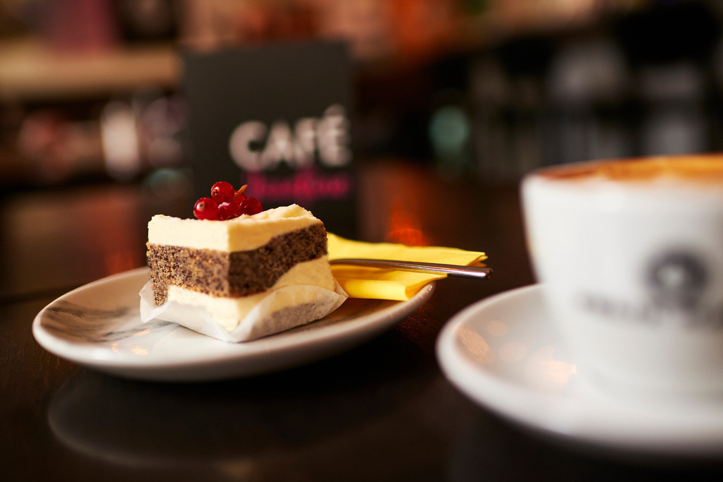 Cafe Josefine | WIen, Austria - February 13, 2018: Cafe Josefine; auf dem Tisch stehend eine Topfen-Mohn Schnitte mit Beeren, eine Speisekarte und eine Tasse Felix Kaffe (Melange). - Realisiert mit Pictrs.com