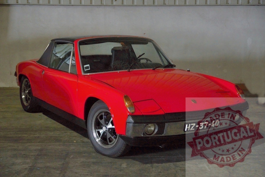 Red Porsche 914 vintage sports car in garage | Red Porsche 914 vintage sports car parked inside a garage - Realized with Pictrs.com