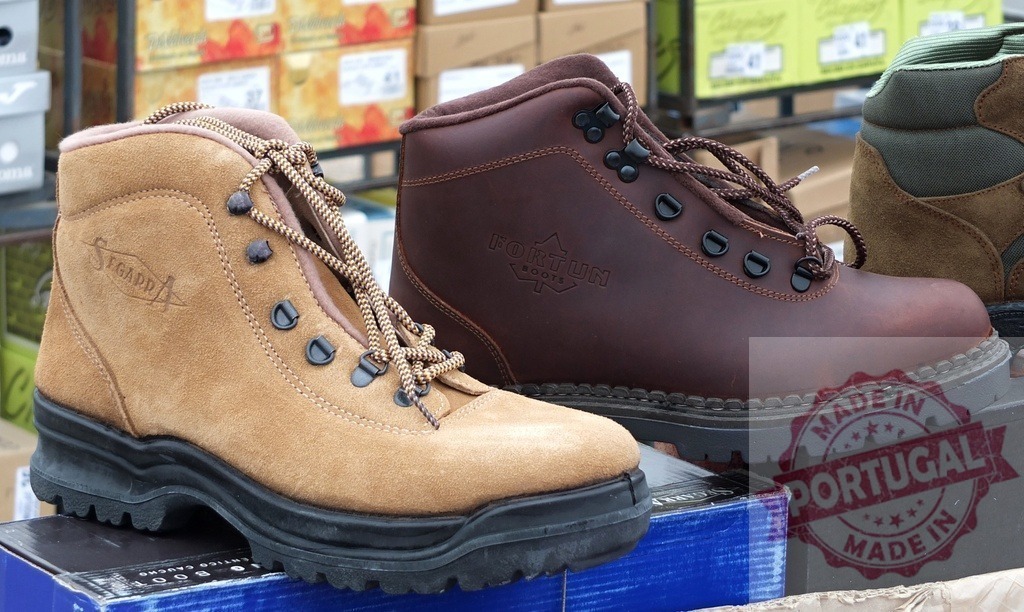 Outdoor hiking boots for trekking and exploring nature | Various pairs of new brown and tan hiking boots on display at a market - Realized with Pictrs.com