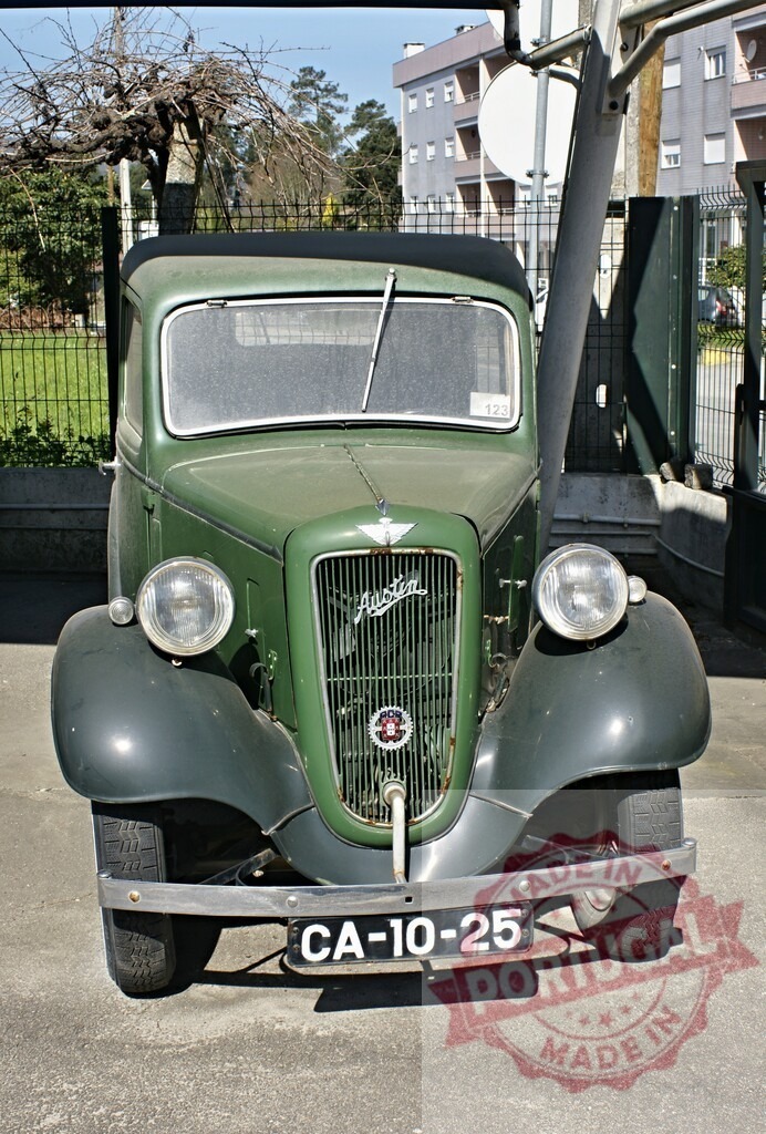Classic Austin Seven Ruby Green Pickup Truck Parked in Urban Setting | Vintage Austin Seven Ruby, a classic green pickup truck, parked in an urban environment, showcasing its timeless design and historical significance - Realisiert mit Pictrs.com