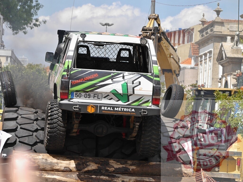 Four-wheel drive vehicle climbing over huge tires in an urban environment | Powerful four-wheel drive vehicle overcoming obstacles in an urban environment, showcasing its off-road capabilities - Realized with Pictrs.com