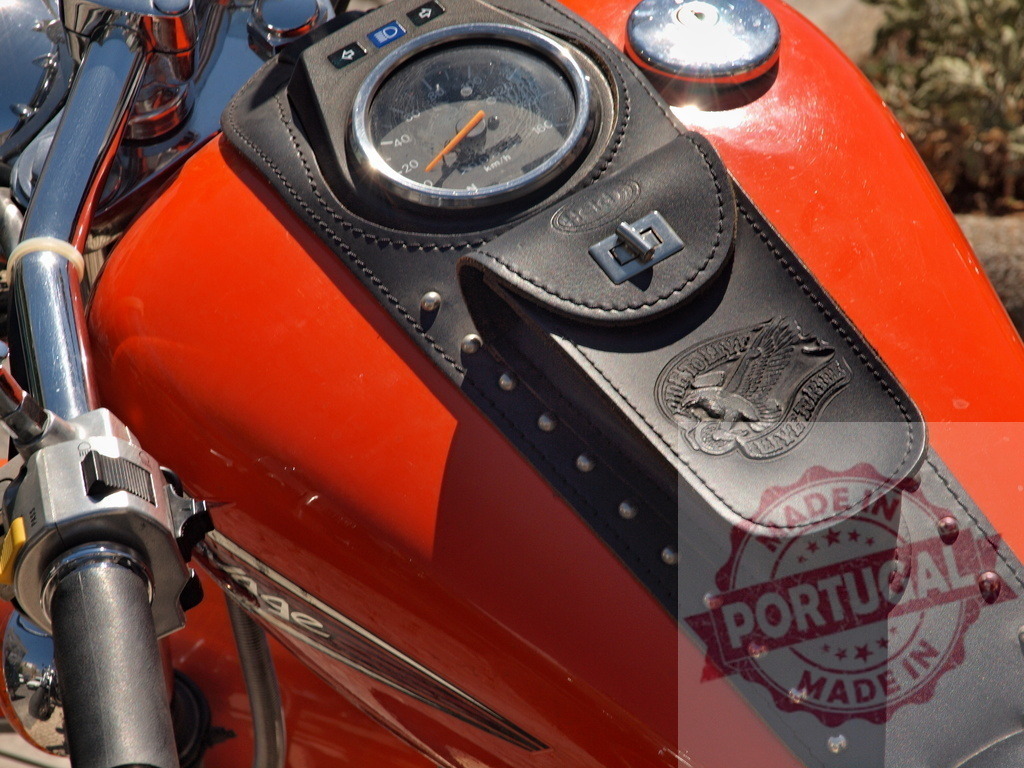 Classic orange motorcycle gas tank with leather pouch | Orange motorcycle gas tank featuring a leather console pouch with embossed eagle design and chrome details - Realisiert mit Pictrs.com