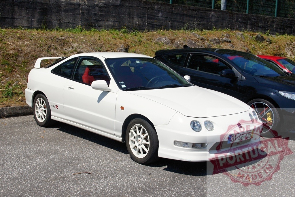 White Honda Integra Type R parked near other sports cars | Gleaming white Honda Integra Type R parked, showcasing its sporty design and iconic status among Japanese performance vehicles - Realisiert mit Pictrs.com