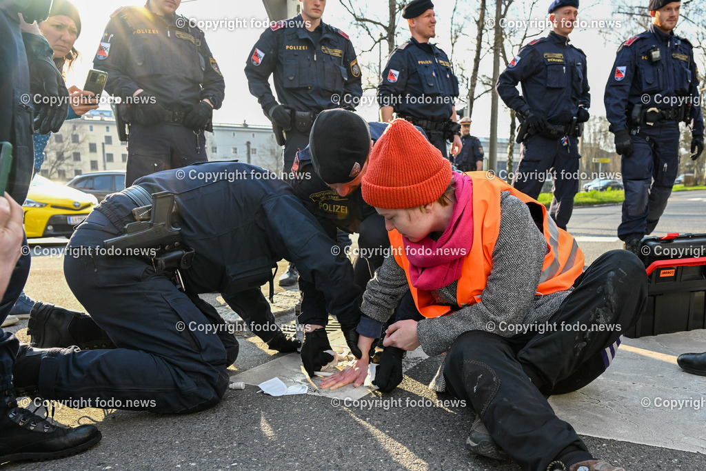  Klimagegner Linz Waldeggstrasse_ Klimakleber_ 20.03.2023-85 | 20.03.2023, Linz, AUT, Klimagegner Linz Klimakleber, im Bild Klimagegner kleben auf der Strasse, Linz Waldeggstrasse, Polizei, Verkehr, Zebrastreifen, Fussgaengeruebergang, Transparent, Demo, Klimawandel
