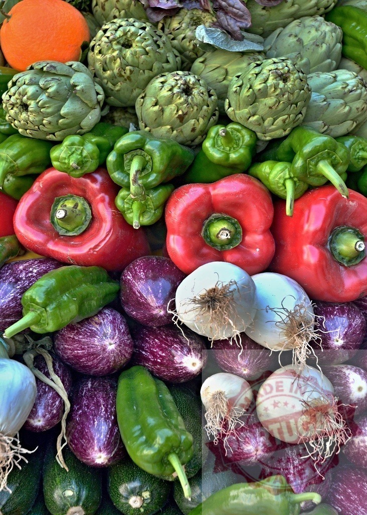 Fresh organic market vegetables including bell peppers and eggplants | Colorful variety of fresh organic vegetables arranged at a farmers market stall - Realized with Pictrs.com