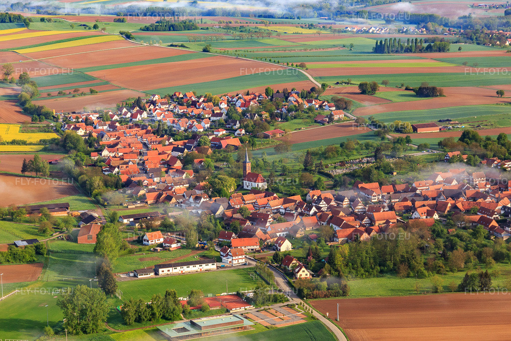 Vue aérienne: Cimetière et église protestante de Hunspach à l'extrémité sud-est du village à Hunspach dans le département Bas Rhin, France – .Photo: IMG_113827.jpg prise le 29/04/2019 par Werner Riehm/FLY-FOTO.eu – Résolution de l'original: 5370 x 3580 px – Paroisses Protestantes du 