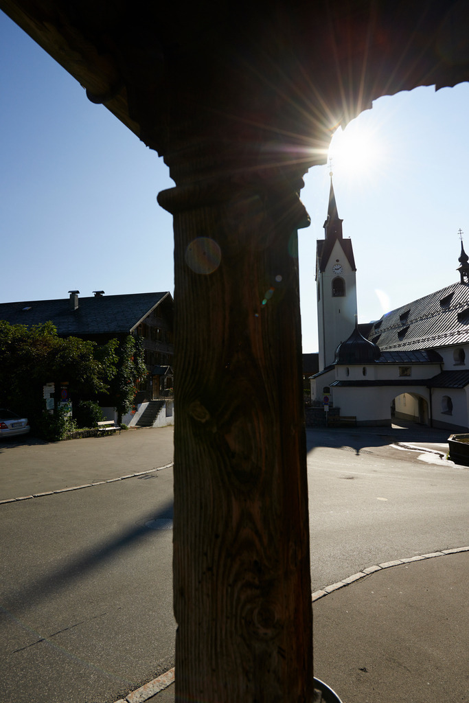 Blick auf Dorfplatz | Schwarzenberg, Austria - August 04, 2014: Blick auf den Dorfplatz mit Kirche durch den das Alte Tanzhaus. - Realisiert mit Pictrs.com