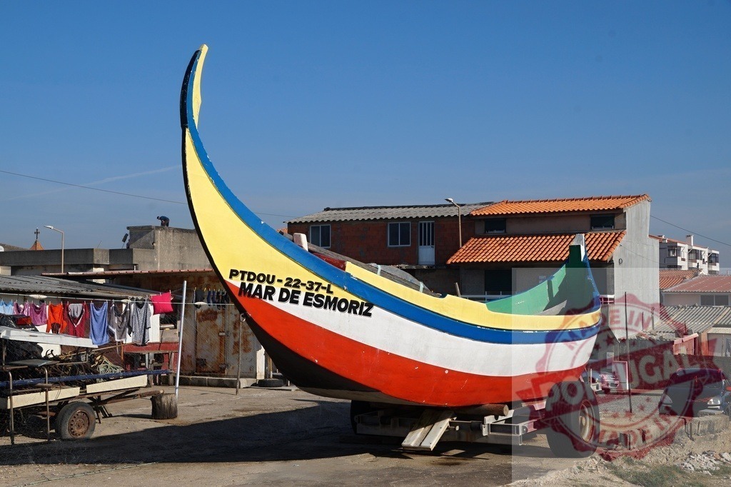 Colorful moliceiro boat dry docked in Portugal | Colorful moliceiro boat dry docked on a trailer in a coastal village - Realized with Pictrs.com