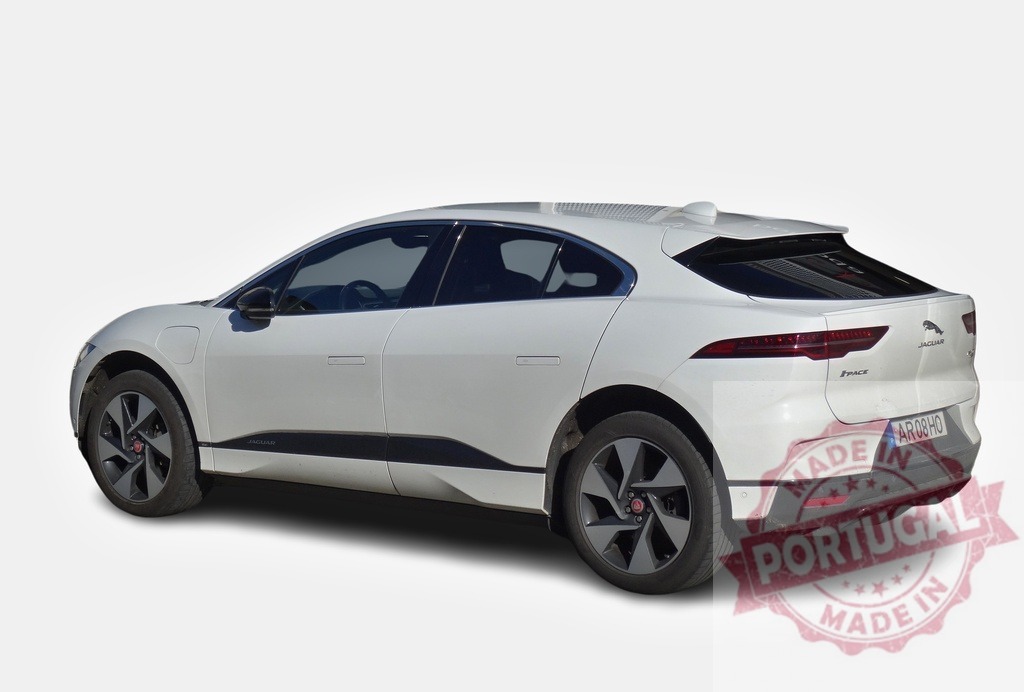 White Jaguar I-Pace electric car parked on white background | Modern white Jaguar I-Pace electric car parked on a white background, showcasing its sleek design and eco-friendly technology - Realized with Pictrs.com