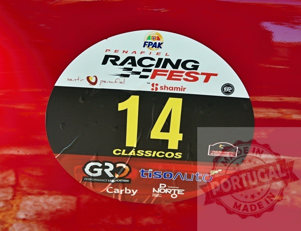 Number 14 sticker on a red racing car participating in Penafiel Racing Fest | Close-up of number 14 sticker on a red racing car door during Penafiel Racing Fest, a motorsport event - Realized with Pictrs.com