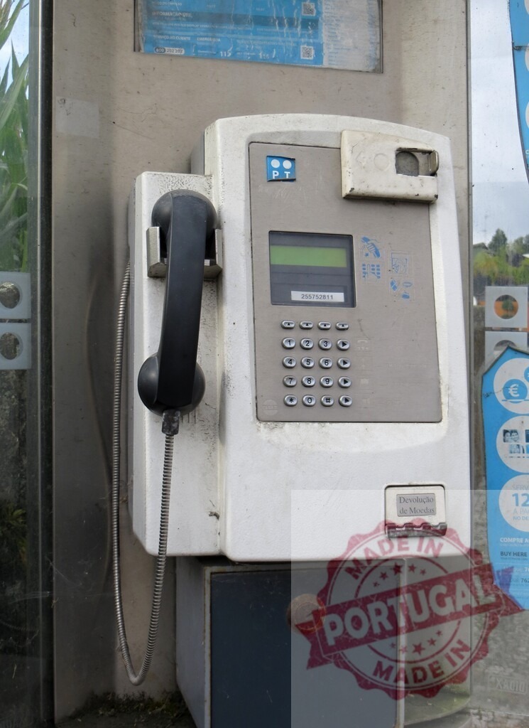 Public pay phone showing signs of age and weathering | Old and weathered public pay phone in a phone booth, showing signs of decay and wear - Realized with Pictrs.com