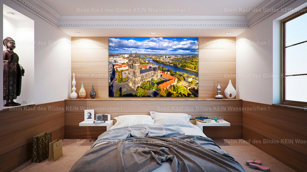 Luftbild Magdeburg Dom neu im Herbst und Elbe-0047 wall_bedroom | Der Magdeburger Dom als großformatiges Wandbild: Dieses Wohnraum-Mockup zeigt, wie das eindrucksvolle Luftbild des gotischen Wahrzeichens mit seinen markanten Doppeltürmen, den historischen Gebäuden und der Elbe im Hintergrund zur Geltung kommt. Die kräftigen Farben, die herbstlichen Baumkronen und die weiten Wolkenformationen verleihen dem Motiv eine besondere Tiefe.Ob im Schlafzimmer, Wohnzimmer oder in einem repräsentativen Raum – als Leinwand oder Acrylglasbild bringt diese Aufnahme ein Stück Magdeburg an die Wand. Das Panorama verbindet Stadtgeschichte und Landschaft und eignet sich besonders für Menschen, die ihrer Heimat verbunden sind oder ein außergewöhnliches Geschenk mit regionalem Bezug suchen.Das Motiv wurde von mir selbst fotografiert und ist als hochwertiges Wandbild erhältlich. Entdecken Sie Magdeburg von oben und finden Sie Ihr persönliches Lieblingsmotiv. - Realisiert mit Pictrs.com