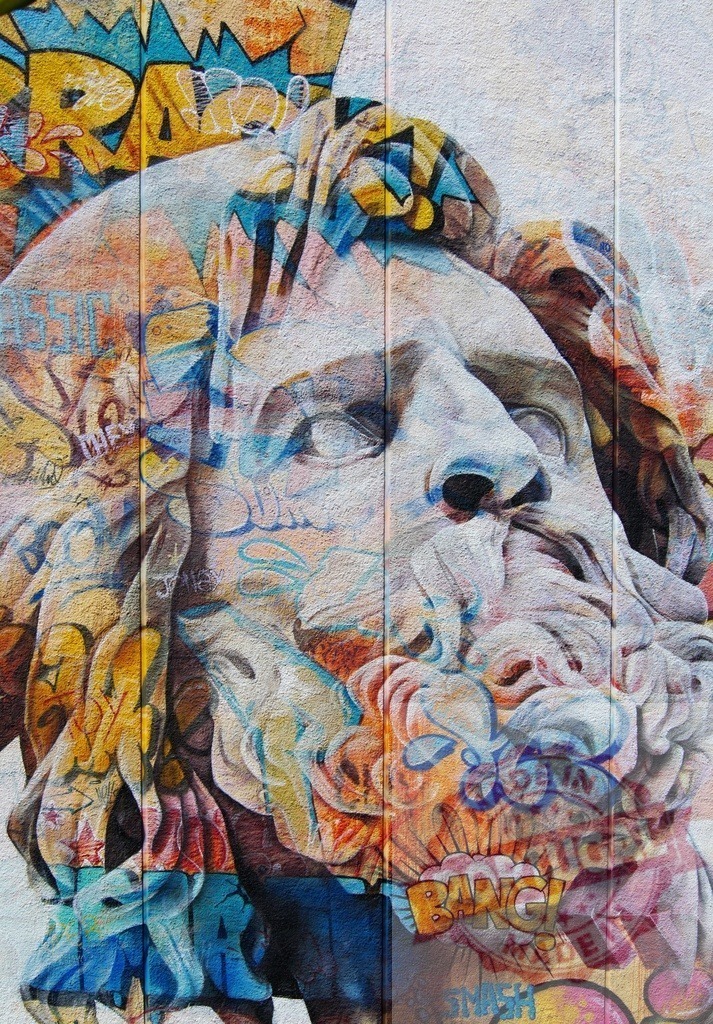 Classical sculpture head merging with colorful street art | Classical bust covered with vibrant graffiti creating a juxtaposition of old and new - Realized with Pictrs.com