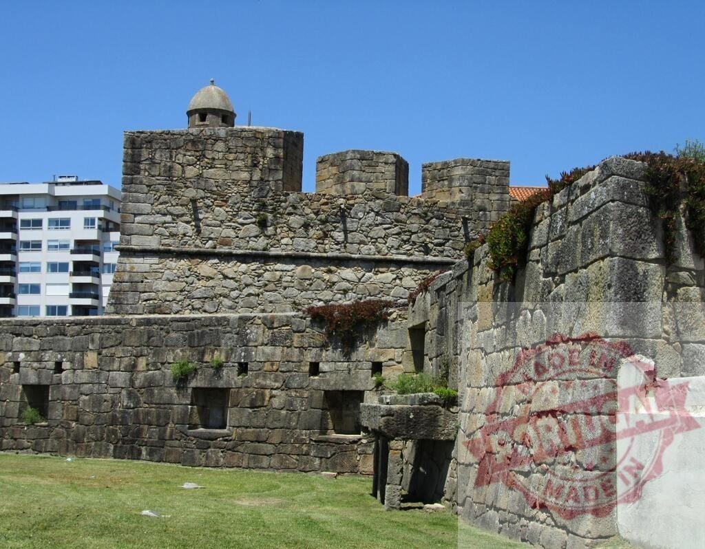 Castelo do Queijo fortification walls in Porto, Portugal. Portugal - Norte | Castelo do Queijo, also known as Forte de São Francisco Xavier, standing against a clear blue sky - Realized with Pictrs.com