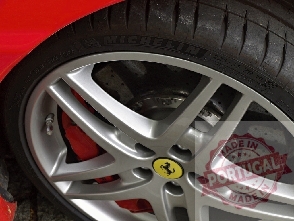 Ferrari sports car wheel showing Michelin tire and red brake | Ferrari sports car wheel close up featuring Michelin tire, alloy rim, and red brake caliper - Realisiert mit Pictrs.com