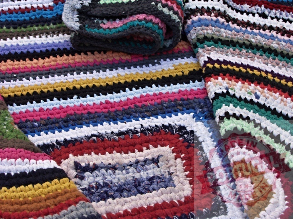 Colorful handmade rag rugs showing traditional craftsmanship | Close-up of vibrant handmade rag rugs, showcasing traditional weaving techniques and repurposed materials - Realized with Pictrs.com