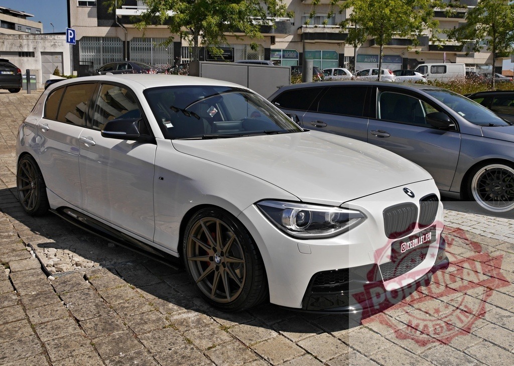BMW 1 Series custom hatchback parked on street | White BMW 1 Series hatchback showing aftermarket tuning and custom wheels - Realisiert mit Pictrs.com