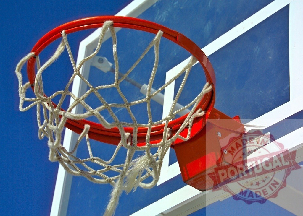 Basketball hoop with frayed net against blue sky inviting players for a game | Red basketball hoop with white net against a vibrant blue sky, ready for a game - Realized with Pictrs.com