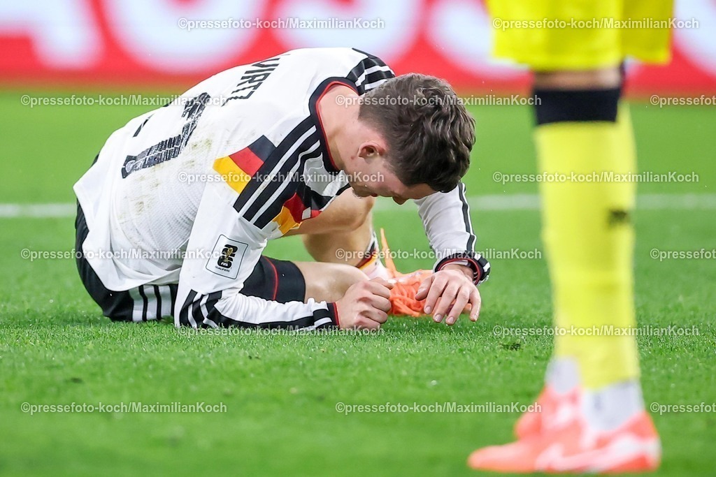 DFB14112501067 | 14.11.2025, Fußball, Länderspiel, WM-Qualifikation Europa, Deutschland - Luxemburg, Stade de Luxembourg (Croix de Gasperich, Luxemburg), 9. Spieltag, Saison 2025 2026: Florian Wirtz (GER #17) liegt mit Schmerzen im Strafraum auf dem Spielfeld  Regulations prohibit any use of photographs as image sequences and or quasi-video.