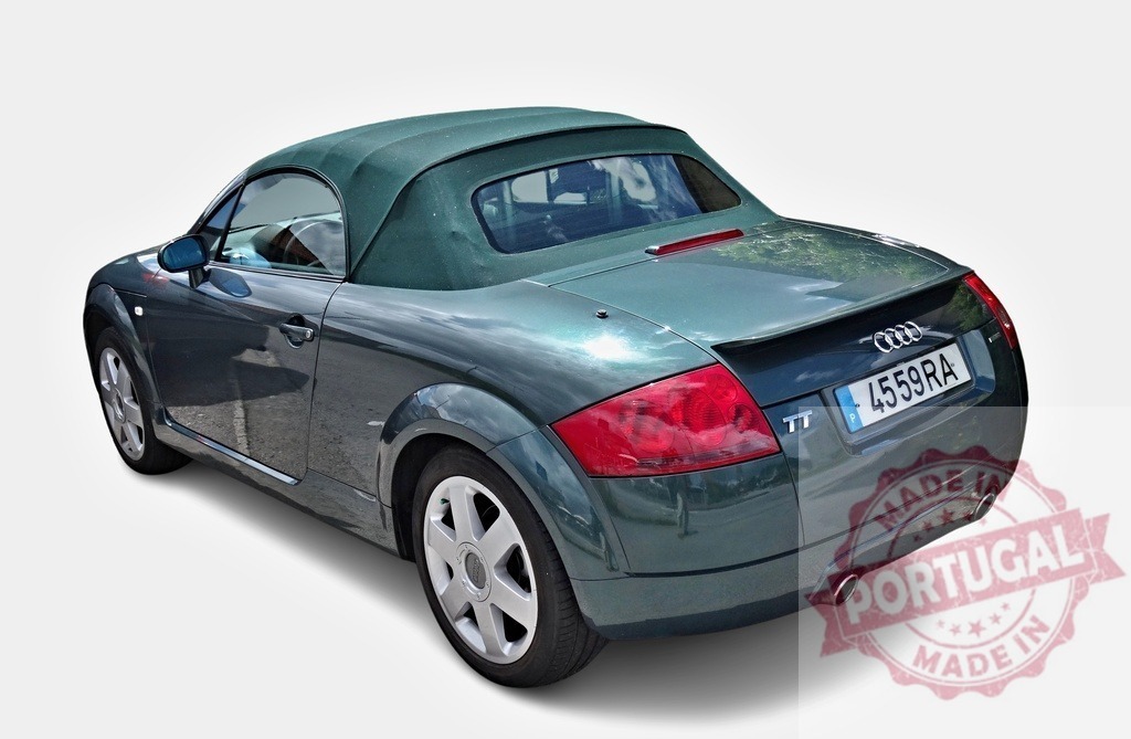 Green Audi TT roadster parked with soft top showing rear window | Stylish green Audi TT roadster parked, showcasing its soft top and rear window - Realized with Pictrs.com
