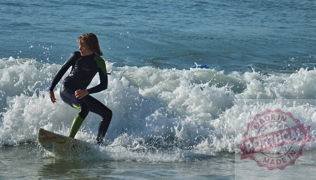 Adolescent surfer riding ocean wave on surfboard | Young surfer balancing on a surfboard, riding a breaking ocean wave - Realized with Pictrs.com