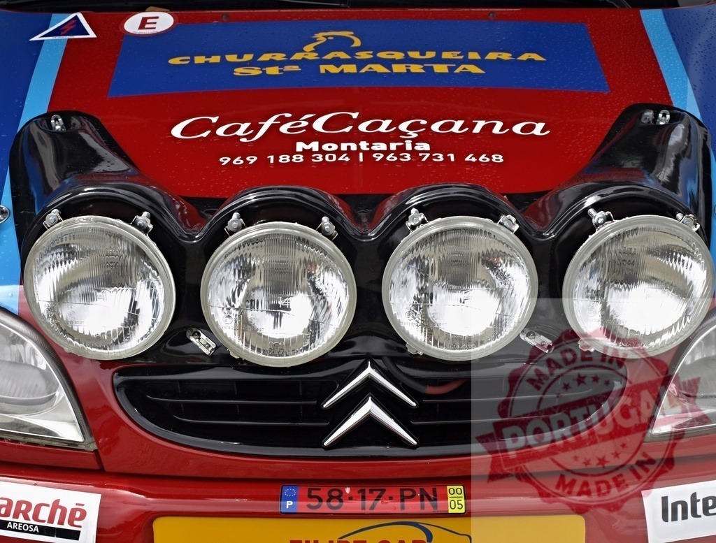 Rally car auxiliary lights and sponsor branding | Rally car front featuring auxiliary lights, Citroën badge, and sponsor logos - Realisiert mit Pictrs.com