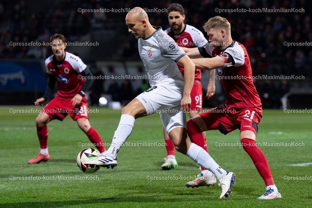 xYDR12032501163 | 12.03.2025, xydrx, Fußball, Viktoria Köln - Rot-Weiss Essen, 3.Liga, Sportpark Höhenberg, Saison 2024 2025: Tobias Kraulich (Rot-Weiss Essen #33) im Zweikampf gegen Lars Dietz (Viktoria Köln #2). DFB regulations prohibit any use of photographs as image sequences and or quasi-video.