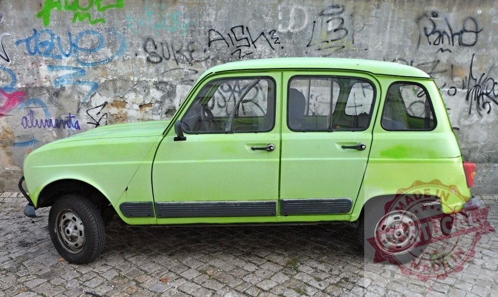 Light green Renault 4 parked near graffiti wall | Light green vintage Renault 4 parked in front of a weathered wall covered in graffiti - Realized with Pictrs.com