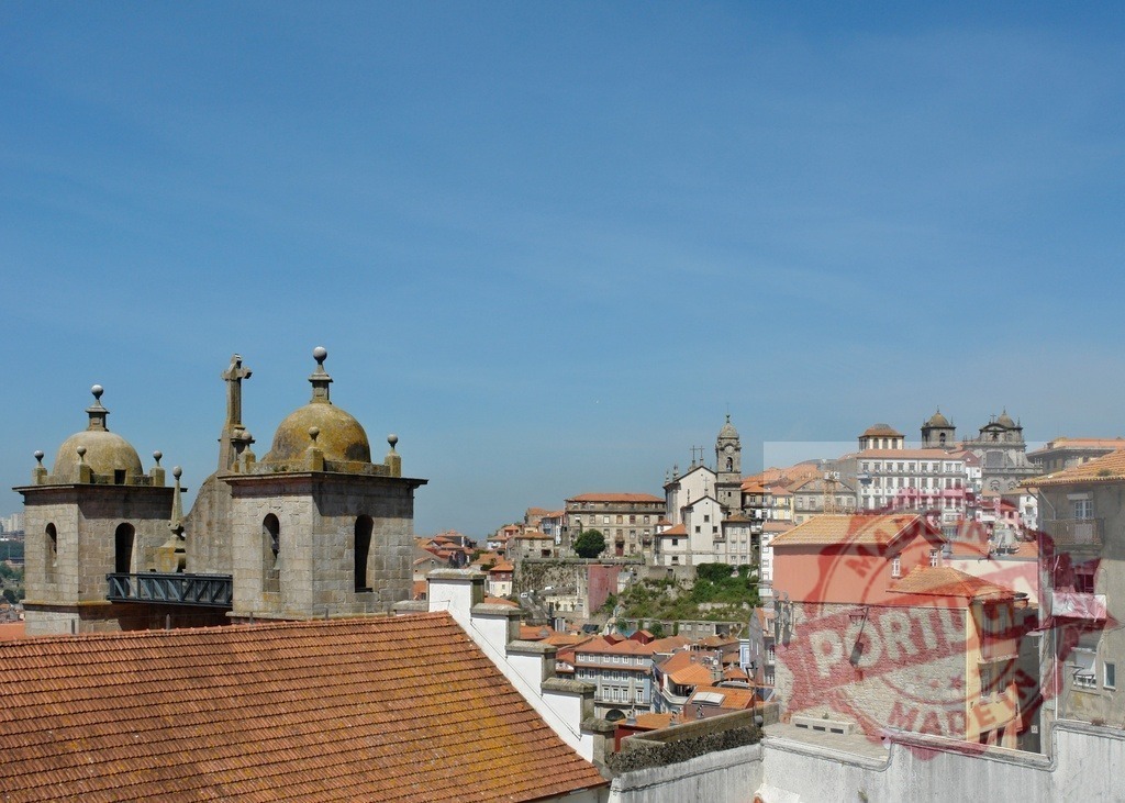 Porto city skyline architecture with historic church domes. Porto - Portugal | Overhead view showing historic Porto cityscape with traditional rooftops under a clear blue sky - Realized with Pictrs.com