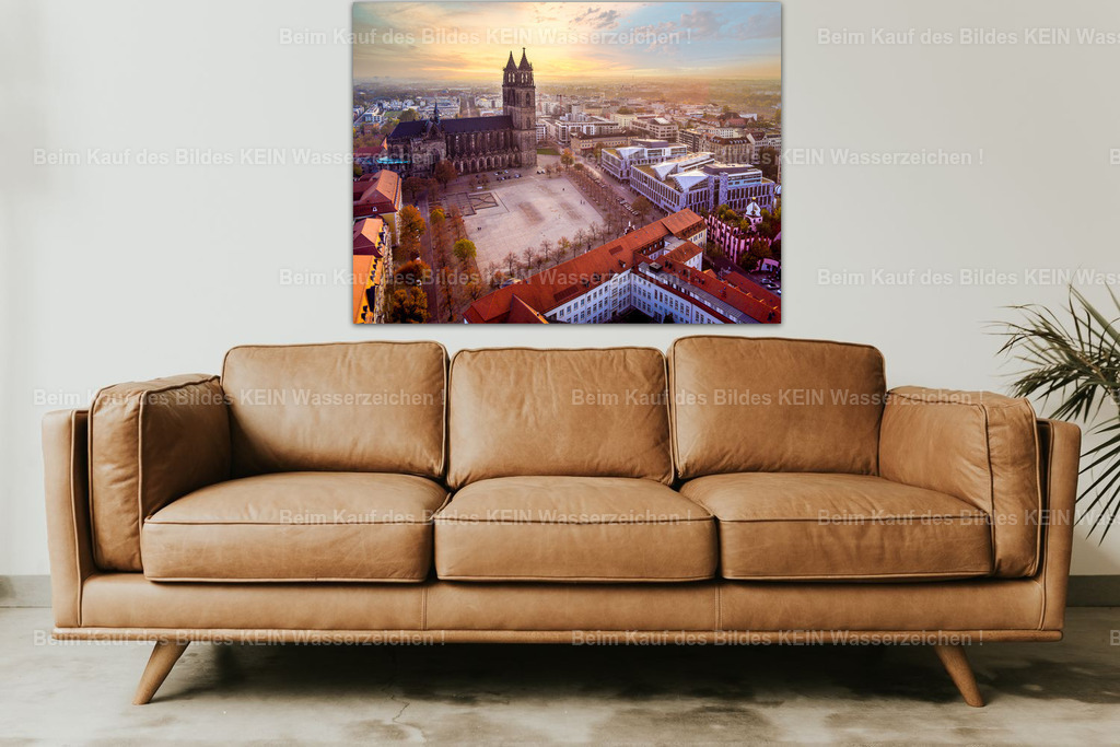 Magdeburg Dom Sonnenuntergang-0039 wall_living_room | Der Magdeburger Dom im warmen Abendlicht: Dieses Luftbild zeigt das berühmte Wahrzeichen der Landeshauptstadt zusammen mit dem weitläufigen Domplatz und den umliegenden historischen und modernen Gebäuden. Der goldene Himmel, die rötlichen Dächer und die markante Silhouette des Doms verleihen der Aufnahme eine besonders stimmungsvolle Wirkung.Als großformatige Leinwand über einer Couch wird das Motiv zum Blickfang im Wohnbereich. Die warmen Farben harmonieren mit natürlichen Materialien und schaffen eine Verbindung zwischen moderner Einrichtung und der Geschichte Magdeburgs. Das Panorama eignet sich für alle, die ihre Verbundenheit zur Stadt zeigen oder einen besonderen regionalen Akzent in ihrem Zuhause setzen möchten.Das Motiv stammt aus meinem eigenen Luftbildarchiv und ist als Wandbild auf Leinwand oder Acrylglas erhältlich. - Realisiert mit Pictrs.com