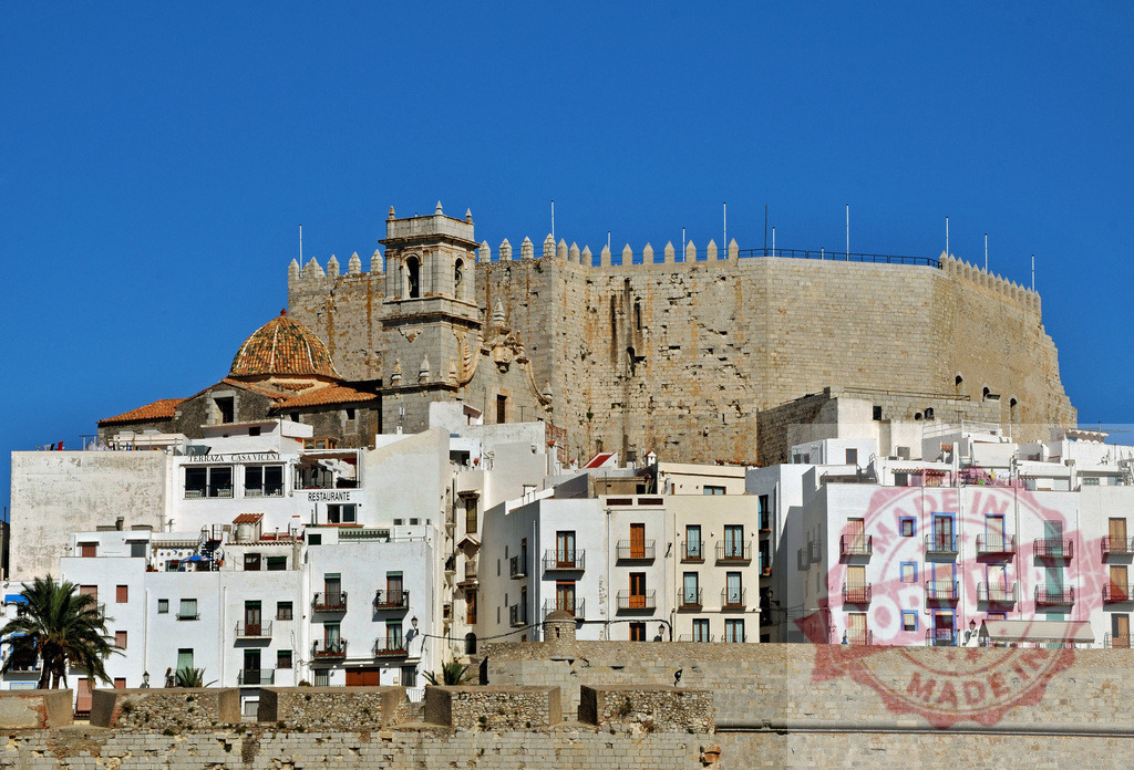 Peñíscola castle and old town against blue sky | Peñíscola castle fortress overseeing the historic whitewashed village and Mediterranean Sea - Realized with Pictrs.com