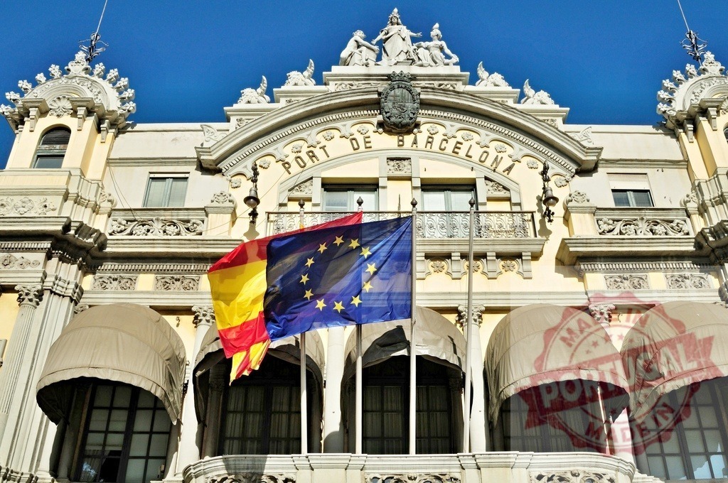 Port de Barcelona building flying Spain European Union flags. Spain - Barcelona | Port de Barcelona building facade flying flags under blue sky, representing international connections and commerce - Realisiert mit Pictrs.com