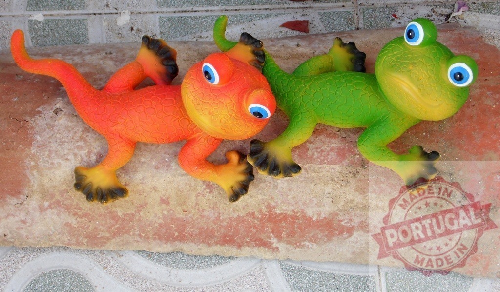 Colorful gecko lizard toy statues for home garden decoration | Two vibrant gecko figurines, one orange and one green, adorning a garden surface - Realized with Pictrs.com