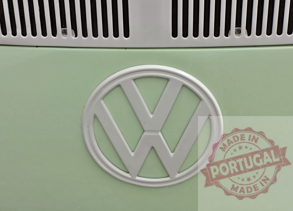 Close-up of Volkswagen logo on light green vintage van | Volkswagen VW logo on a light green vintage van showing its front grill - Realisiert mit Pictrs.com