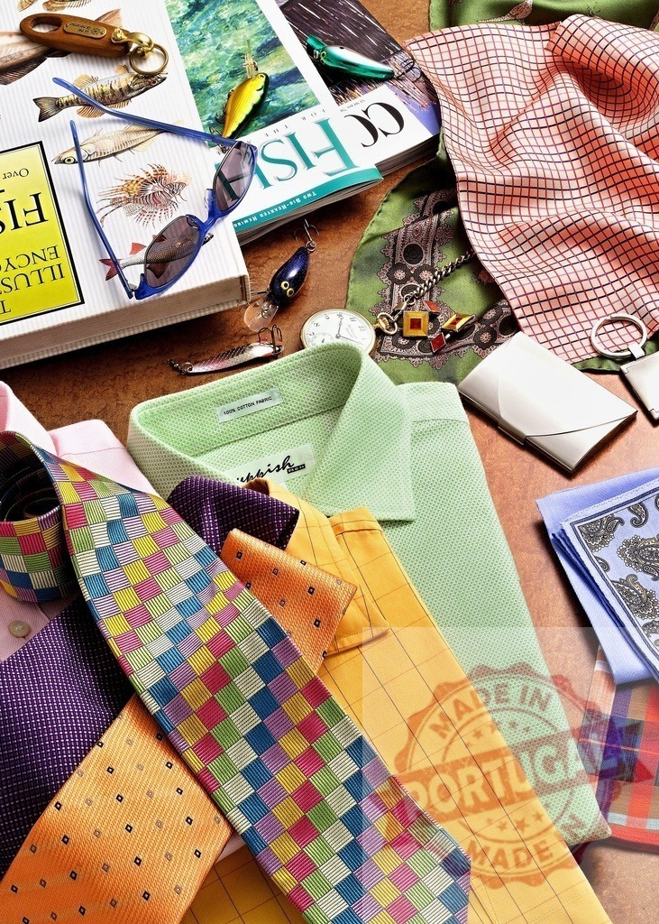 Men's fashion items and fishing gear creating a lifestyle collage | Colorful men's fashion shirts, ties, and accessories with fishing lures and book for leisure activity - Realized with Pictrs.com